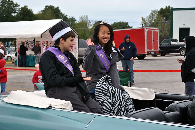 The winners of the 2012 Olde Tyme Apple Festival King and Queen contest - Jacob Vogt and Tiffany Lor - enjoy sharing in their victory as they ride in the 2012 Apple Festival parade in Versailles. 