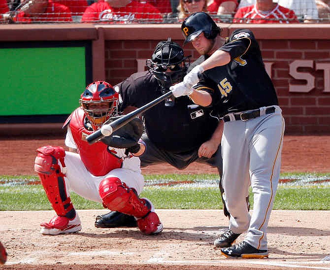 Pittsburgh Pirates pitcher Gerrit Cole (45) hits an RBI single against the St. Louis Cardinals in the second inning of Game 2 of baseball's National League division series on Friday, Oct. 4, 2013, in St. Louis. Catching for the Cardinals is Yadier Molina. 