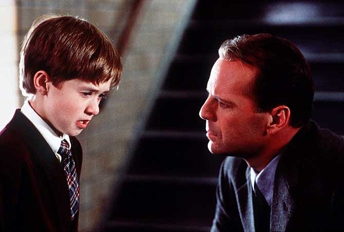 In this publicity photo released by Spyglass Entertainment, Haley Joel Osment, left, and Bruce Willis appear in a scene from the film "The Sixth Sense," a tale of a child who can see ghosts. Revealing secret endings and plot twists has brought on wrath since the dawn of cinema, straight through VCRS to streaming and DVRs. But exactly what is the magic formula for spoiler grace. 