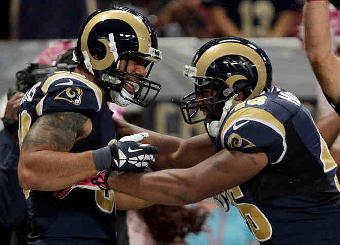 St. Louis Rams tight end Lance Kendricks, left, is congratulated by Cory Harkey after catching a 16-yard pass for a touchdown during the second quarter of an NFL football game against the Jacksonville Jaguars Sunday, Oct. 6, 2013, in St. Louis. 
