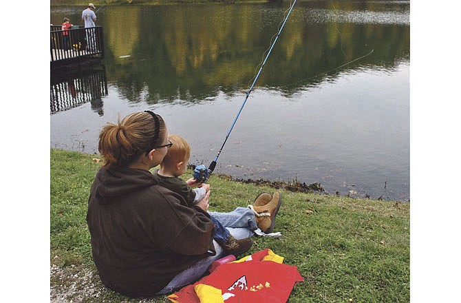 Miranda Thyng helps her son Nathaniel fish during the Third Annual Take a Kid Fishing Derby in Osage Beach last year.