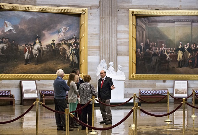 Rep. Louie Gohmert, R-Texas, escorts a group of constituents through the Capitol Rotunda during a lull in activity in the House of Representatives, Monday, Oct. 7, 2013, in Washington. The government partially shut down last week amid Washington gridlock and faces a make-or-break deadline later this month about the nation's borrowing power.