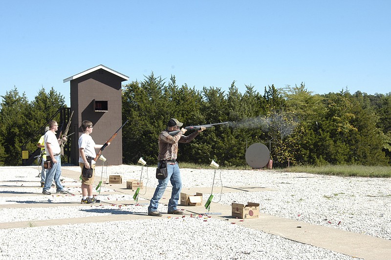 Democrat photo / David A. Wilson
Using a 12-gauge Beretta shotgun, Trenton Patterson fires as the orange-colored clay disc is launched by the voice activated system. A keen eye can see the expended shell as it ejects from the self-loading shotgun. The 15 shooters were in teams of five.