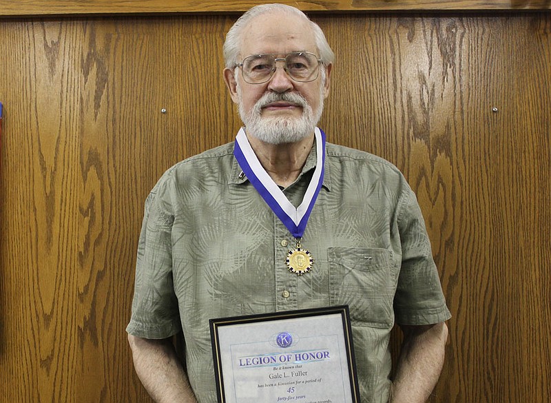  Gale Fuller poses with his George Hixson Fellowship medal and one of the many Legion of Honor certificates he has earned in his time at the Fulton Kiwanis Club. Fuller has maintained a perfect Kiwanis attendance record for 57 years.