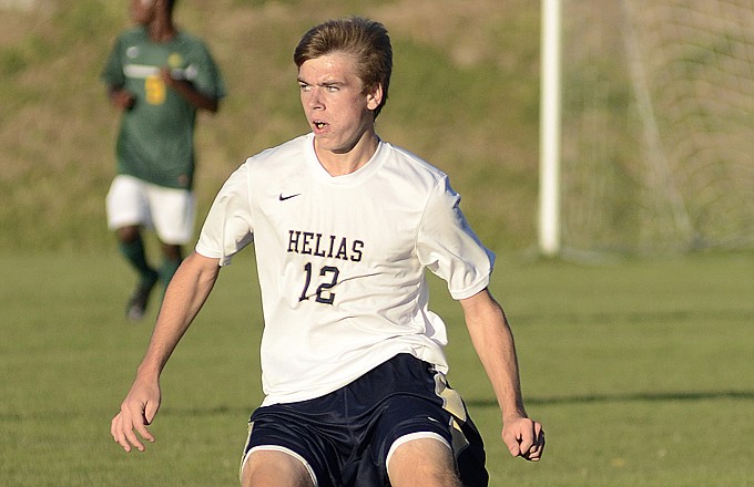 Helias' Braden Remmert moves the ball along the sideline during the first half Tuesday against Rock Bridge at the 179 Soccer Park.