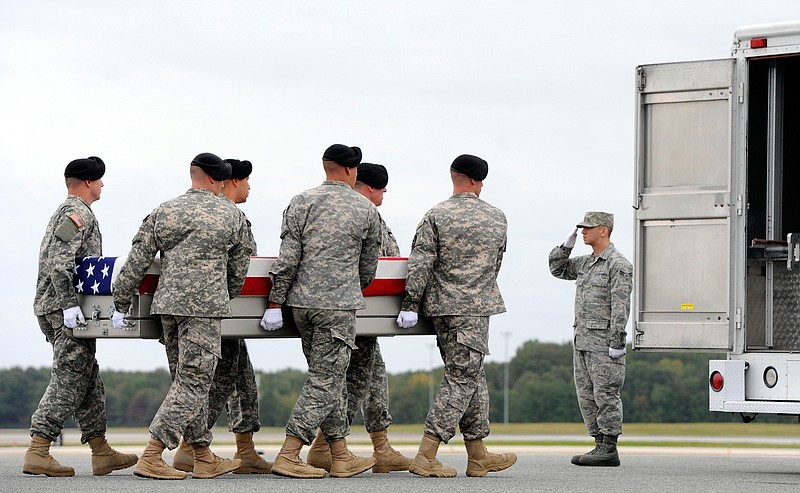 An Army carry team moves a transfer case Wednesday containing the remains of Pfc. Cody J. Patterson at Dover Air Force Base, Del. According to the Department of Defense, Patterson, 24, of Philomath, Ore., died Oct. 6, Afghanistan of injuries sustained when enemy forces attacked his unit with an improvised explosive device.