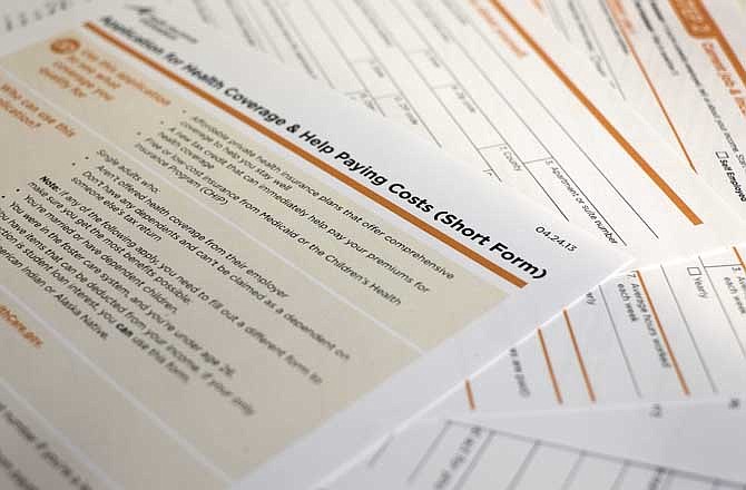 This April 30, 2013 file photo shows the short form for the new federal Affordable Care Act application in Washington.