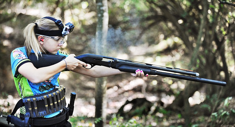 While wearing a small video camera on her forehead, Katie Francis fires a shotgun as she demonstrates her shooting skills for a film crew from ABC's 20/20 news show.