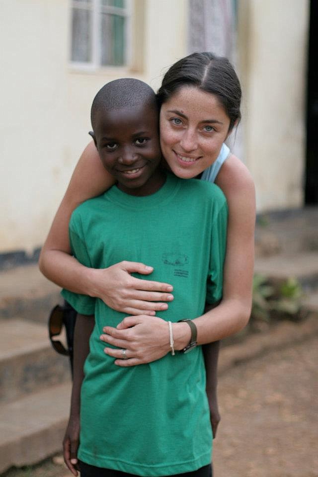 Rebecca Neuenswander Welsh hugs a child named Henry on a trip to Uganda.