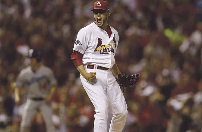 St. Louis Cardinals starting pitcher Joe Kelly reacts after getting Los Angeles Dodgers' Yasiel Puig to strike out during the first inning of Game 1 of the National League baseball championship series Friday, Oct. 11, 2013, in St. Louis.