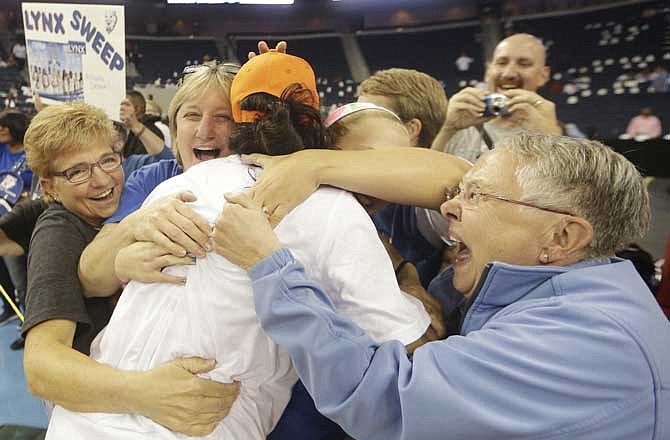 Minnesota Lynx' Monica Wright is embraced by the fans after the second half of Game 3 of the WNBA Finals basketball series against the Atlanta Dream, in Duluth, Ga., Thursday, Oct. 10, 2013. The Minnesota Lynx won 86- 77. 