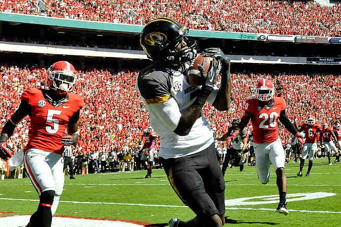 Missouri wide receiver L'Damian Washington (2) makes a catch for a touchdown while defended by Georgia cornerback Damian Swann (5) and defensive back Quincy Mauger (20) during the first half of an NCAA college football game Saturday, Oct. 12, 2013, in Athens, Ga. (AP Photo/Athens Banner-Herald, AJ Reynolds) 