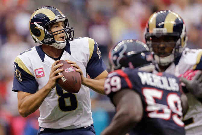 St. Louis Rams quarterback Sam Bradford (8) looks to pass against the Houston Texans during the second quarter of an NFL football game Sunday, Oct. 13, 2013, in Houston, Texas. 