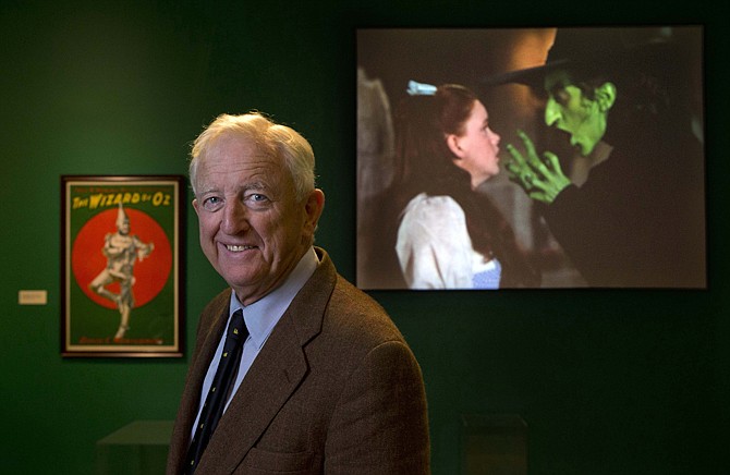 Ham Meserve, of Southport, Maine, the son of actress Margaret Hamilton, poses at the Farnsworth Museum, in Rockland, Maine. Hamilton is seen on the screen at right playing the role of the wicked witch of the West in the movie, "The Wizard of Oz."