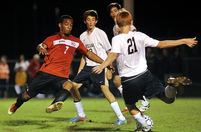 Jefferson City forward Marcus Woodruff lunges to block a clearance kick by Helias midfielder Sam Heckart during Monday night's soccer match at 179 Soccer Park.