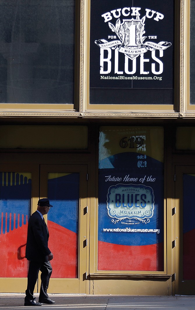 A man walks past past the site of the National Blues Museum, set to open next year, in St. Louis. 