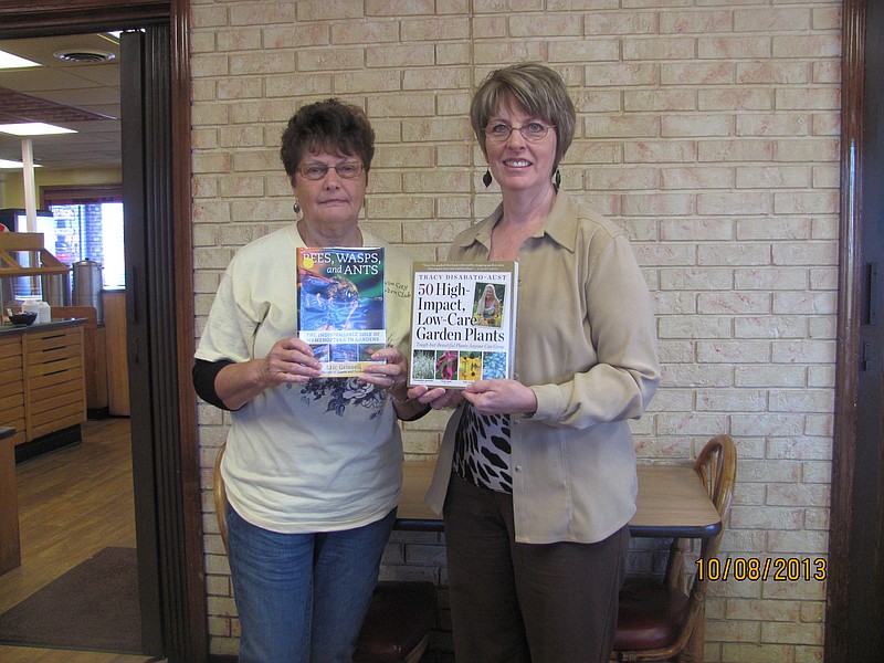 Librarian Connie Walker, right, and Nancy Martin display the books  "Bees,  Wasps, and Ants" and "50 High Impact, Low-Care Garden Plants" donated to the Moniteau County Library at Wood Place by the Twin City Garden Club.