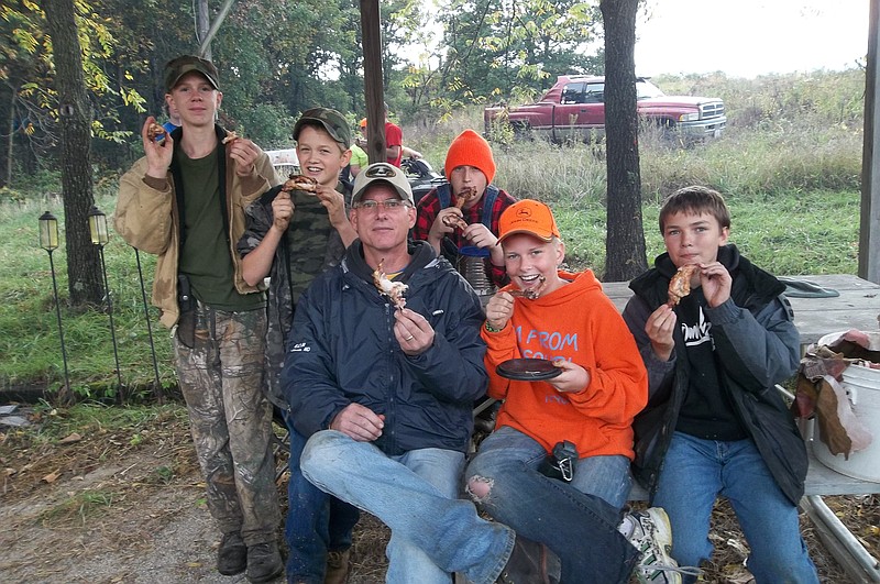 Scouts from Troop 120 share a supper of rabbit which they dressed themselves and cooked on an open fire. 
