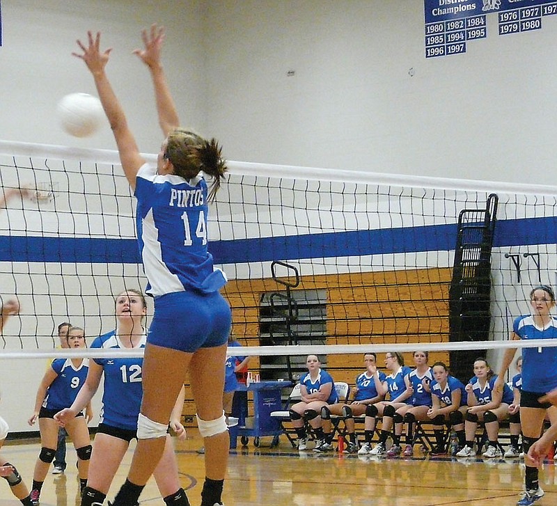 California senior Sydney Deeken (14) executes a successful block during the varsity match at Russellville Thursday. The Lady Pintos defeated the Lady Indians 25-6 and 25-16.