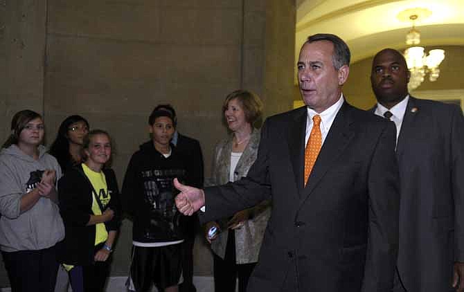 House Speaker John Boehner of Ohio stops to talk to a group of students as he walks back into his office on Capitol Hill in Washington, Wednesday, Oct. 16, 2013. 