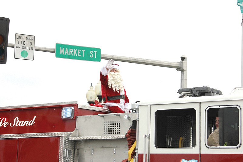 Santa waves to the crowd from atop a fire engine during the 2012 Fulton Jaycees Christmas parade. Registration forms for this year's parade are now available. This year's theme will be "All that Glitters" in recognition of the parade's 65th anniversary.