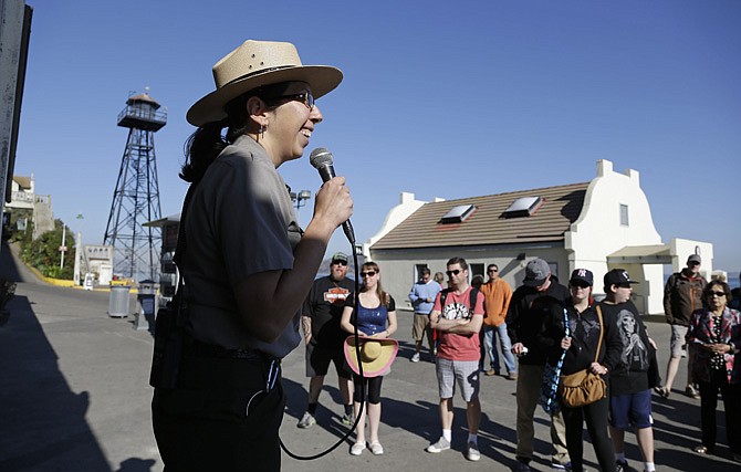 National Park Service Ranger Wendy Solis welcomes visitors to Alcatraz Island Thursday after it reopened following a partial government shutdown, in San Francisco.