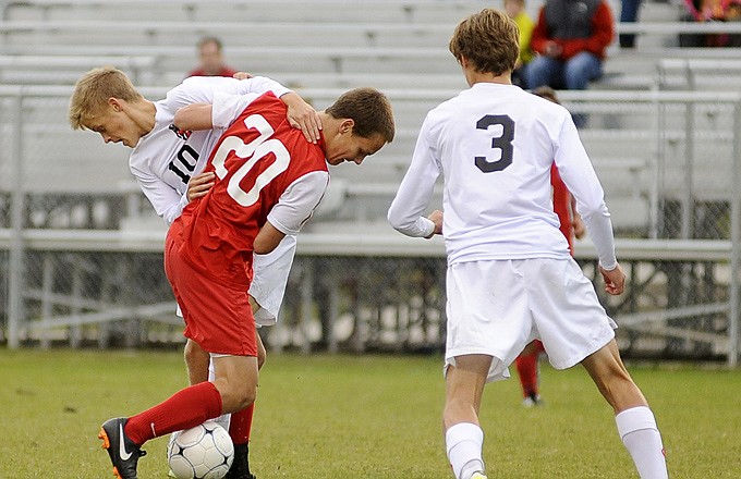 Nathan Luebbert of the Jefferson City and A.J. Anthon of Chaminade get tangled up going for the ball during Friday afternoon's action at the 179 Soccer Park.