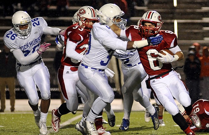 Jake Pridgin of the Jays tries to break from the grip of Javon Goodman of Rockhurst during Friday night's game at Adkins Stadium.