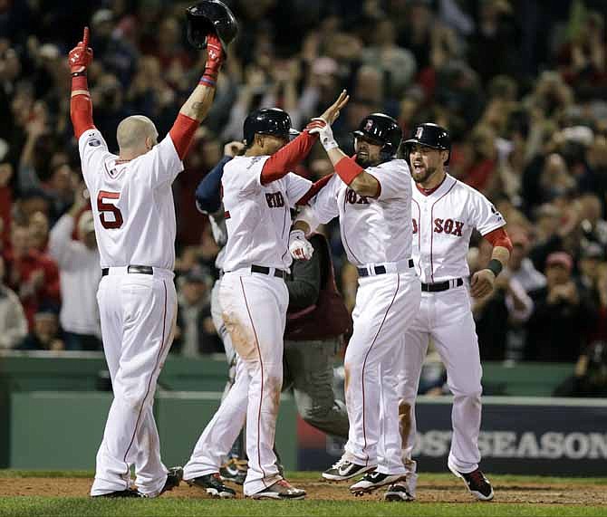 Boston Red Sox's Shane Victorino, second from right, celebrates his grand slam with Jonny Gomes, left, Xander Bogaerts, second from left, and Jacoby Ellsbury, right, in the seventh inning during Game 6 of the American League baseball championship series against the Detroit Tigers on Saturday, Oct. 19, 2013, in Boston.