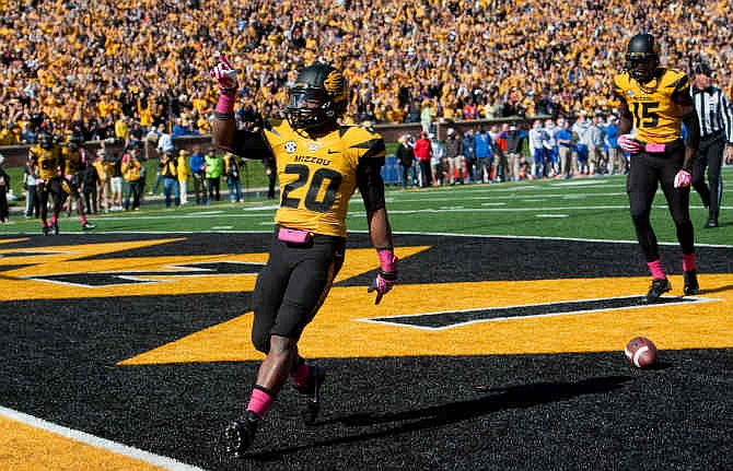 Missouri running back Henry Josey, left, celebrates in front of teammates Dorial Green-Beckham, right, after he scored on a 6-yard run in the third quarter of an NCAA college football game against Florida Saturday, Oct. 19, 2013, in Columbia, Mo. 