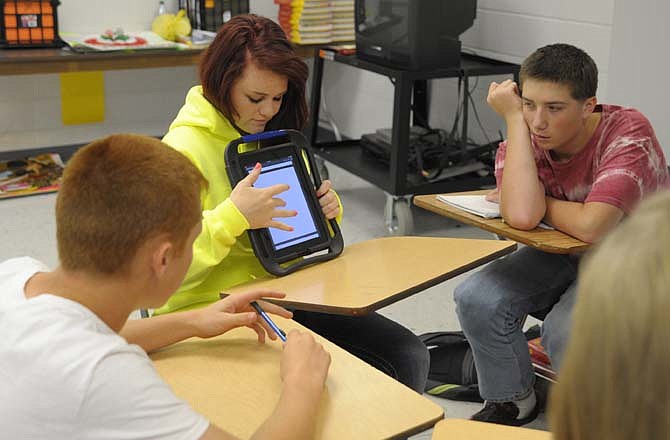 Morgan "Margarita" Schwering operates the new iPad given to Christina Crews for her Spanish classes as Steven "Alejandro" Arney and Jordan "Pedro" Malzner attempt to answer the quiz.