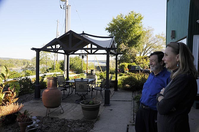 Steve Veile, one of the new owners, and hostess Lenore Abboud admire the Missouri River view from Cliff Manor, a Jefferson City Landmark which serves as a bed and breakfast.