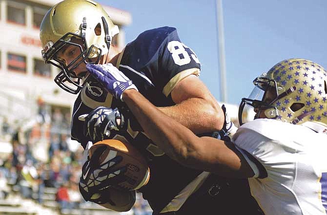 Hale Hentges of Helias looks down at the back corner of the end zone during his touchdown catch after outjumping Damion Baker of C.B.C. for the ball midway through the fourth quarter of Saturday's game at Adkins Stadium in Jefferson City.