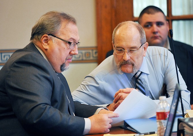 Attorney Donald Catlett, left, confers with client David Hosier prior to the start of Monday's double-murder trial in which Hosier is accused of the 2009 killings of Rodney and Angela Gilpin.