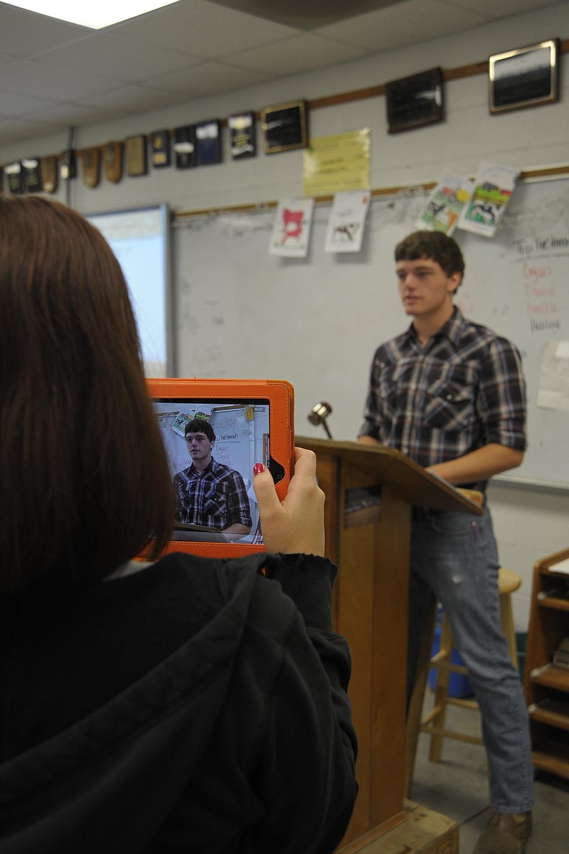 Rachel Call records Josh Bell delivering the opening for FFA chapter meetings with an iPad. News Tribune photo/Michelle Brooks