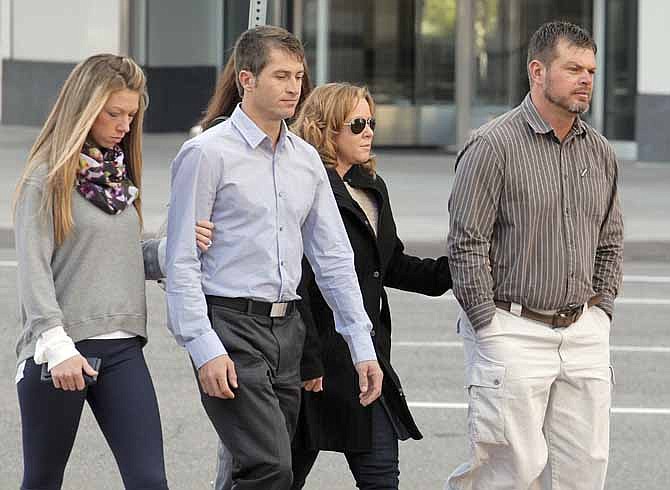 Eric Jensen, 37, right and Ryan Jensen, 33, brothers who owned and operated Jensen Farms, arrive at the federal courthouse in Denver, on Tuesday, Oct. 22, 2013, with family. The two Colorado farmers whose cantaloupes were tied to a 2011 listeria outbreak that killed 33 people pleaded guilty on Tuesday to misdemeanor charges under a deal with federal prosecutors.