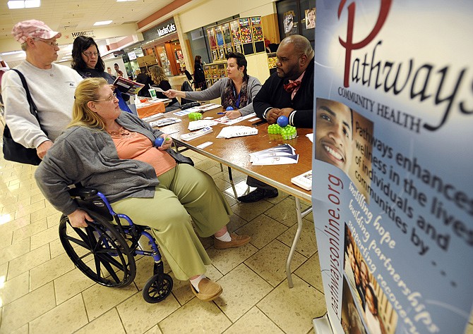 Ella Mae Cotten, left, and Debbie Ridgway, both from Eldon, speak to Pathways Community Health grant development specialist Sara Ferrill and public relations coordinator Johnathan Lowe during a resource fair for persons with disabilities, families and caregivers at the Capital Mall on Wednesday. The Independent Living Resource Center (ILRC), Missouri Rehabilitation and Employment (MORE) Group and Capital Mall partnered to host the event.