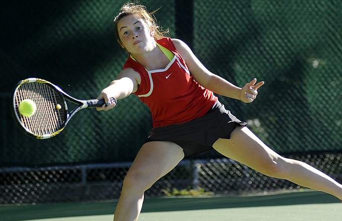 Jefferson City's Kelly Raithel lunges to make the return along the baseline during a match earlier this season at Washington Park. Raithel and her Jefferson City teammates will be in the Class 2 state semifinals today in Springfield.
