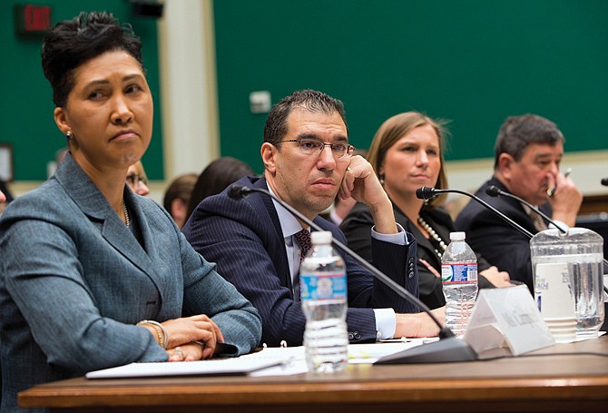 From left, Cheryl Campbell, senior vice president of CGI Federal; Andrew Slavitt, group executive vice president for Optum/QSSI; Lynn Spellecy, corporate counsel for Equifax Workforce Solutions; and John Lau, program director for Serco, listen to questioning during a House Energy and Commerce Committee hearing with contractors that built the federal government's health care websites. The contractors responsible for building the troubled Healthcare.gov website say it was the government's responsibility _ not theirs _ to test it and make sure it worked. (AP Photo/ Evan Vucci)