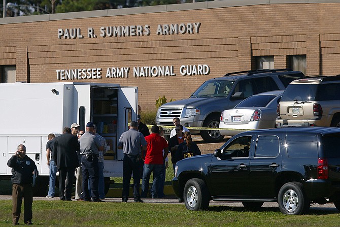 Law enforcement and military personnel on Thursday investigate the scene where shootings occurred at an armory outside a U.S. Navy Base in Millington, Tenn.