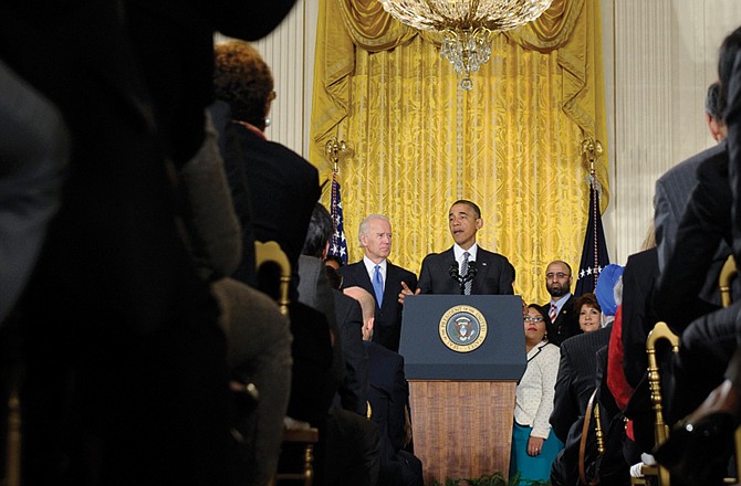 President Barack Obama, standing next to Vice President Joe Biden, urges Congress to take back up comprehensive immigration reform while speaking in the East Room of the White House on Thursday. Obama said now that the partial government shutdown is over, Republicans and Democrats should be able to work together to fix what he called "a broken immigration system." 