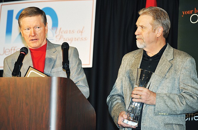 
Lee Wilbers, at podium, thanks his employees as he and Dick Peerson accept the Small Business of the Year award for their firm, Wallstreet Group.