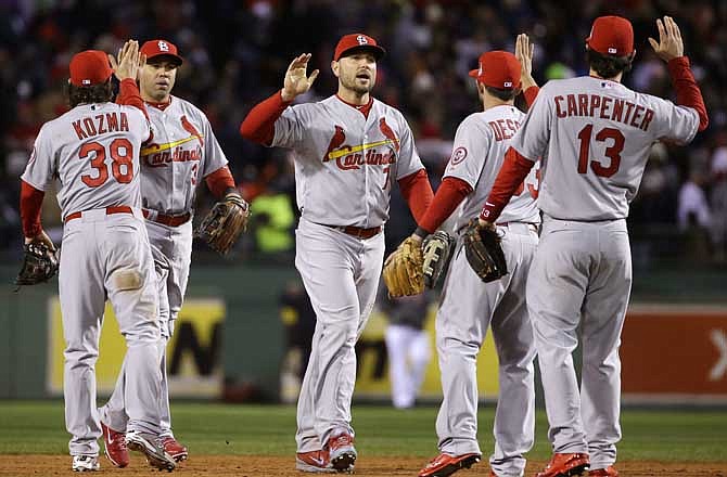 St. Louis Cardinals players celebrate after defeating the Boston Red Sox, 4-2, in Game 2 of baseball's World Series Thursday, Oct. 24, 2013, in Boston. The series is tied at 1-1.