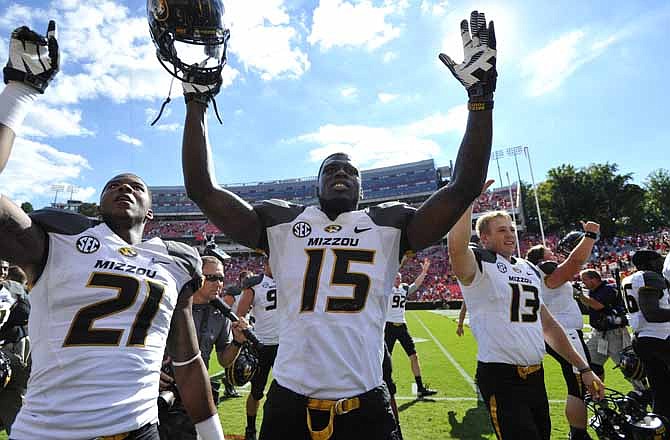 Missouri's Bud Sasser (21), Dorial Green-Beckham (15) and Corbin Berkstresser (13) celebrate after their 41-26 win over Georgia in an NCAA college football game against Missouri Saturday, Oct. 12, 2013 in Athens, Ga. (AP Photo/Athens Banner-Herald, AJ Reynolds)