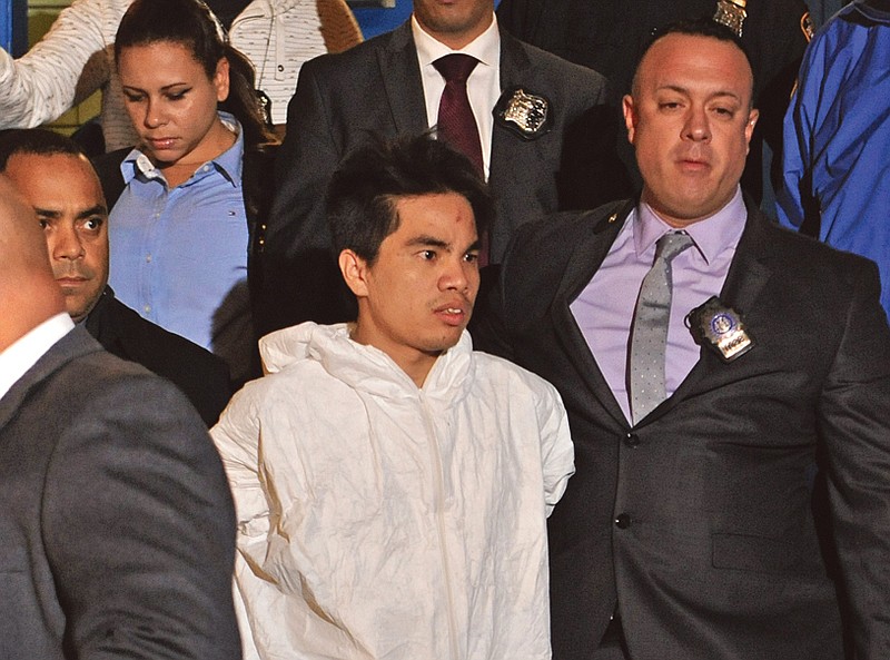 Mingdong Chen, a suspect in the murder of five people in Brooklyn's Sunset Park neighborhood, is walked by police from the 66th precinct in New York.