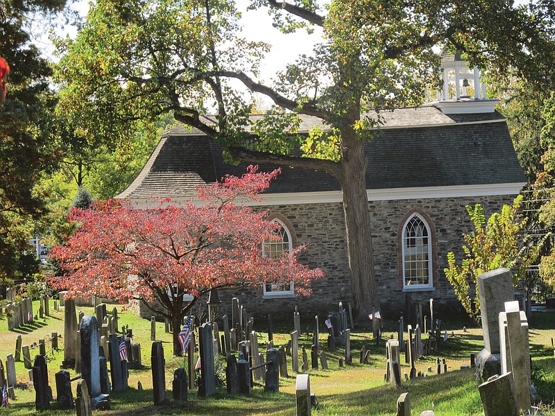 The Old Dutch Church and Sleepy Hollow Cemetery  are shown in Sleepy Hollow, N.Y. The village of Sleepy Hollow is even busier than usual this Halloween, thanks to a new "Sleepy Hollow" TV series inspired by the tale of the Headless Horseman. Inset below, the stars of "Sleepy Hollow" appear in a scene from the TV show. Nicole Beharie, left, plays police Lt. Abbie Mills and Tom Mison plays Ichabod Crane.