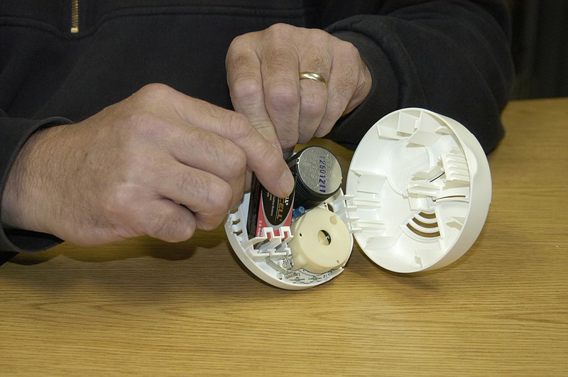 Democrat photo / David A. Wilson
California Fire Chief Allen Smith demonstrates changing a battery in a smoke detector. It is recommended that the batteries be changed each time the clocks are changed for Daylight Saving Time.