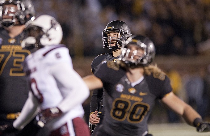Missouri kicker Andrew Baggett (center) watches his field-goal attempt hit off the upright in the second overtime of Saturday night's game against South Carolina at Faurot Field.