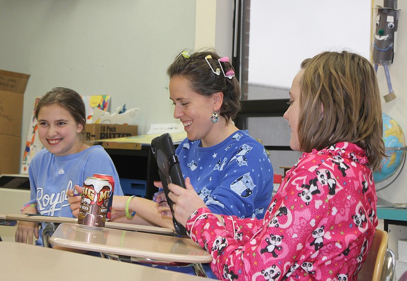 South Callaway Middle School Writing Club member Ellie Edler, club advisor Shannon Bobryk, and fellow club member Hannah Huntsman work on plans for the club's Paws on News newspaper during Tuesday afternoon's meeting. The first edition of Paws on News is planned for the second week of November. They were dressed in pajamas as part of the school's Red Ribbon Week activities.