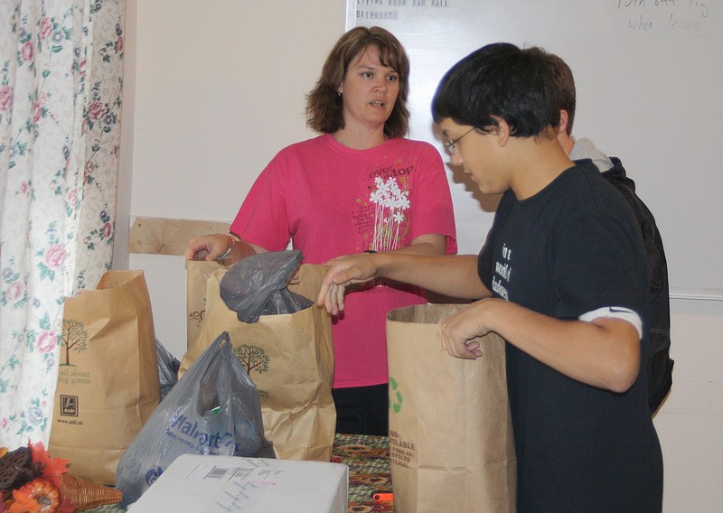 Kingdom Christian Academy teacher Michele Auer and freshman Zeke Barnett deliver donations to Our House in Fulton Thursday afternoon. KCA students gathered paper products, snack foods, canned goods and other supplies for the homeless shelter and for Faith Maternity as part of a community service project.